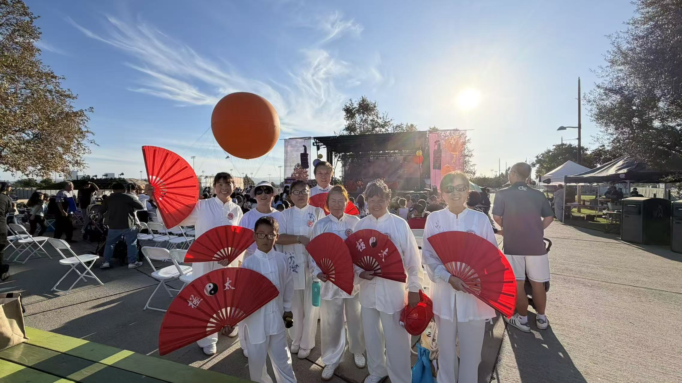 Tai Chi team group photo with red fans